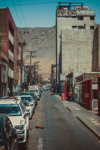 Traffic on road amidst buildings in city