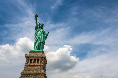 Low angle view of statue against cloudy sky