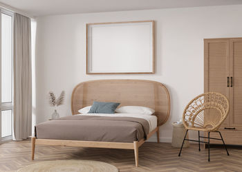 Empty horizontal picture frame on white wall in modern bedroom. mock up interior in boho style. 