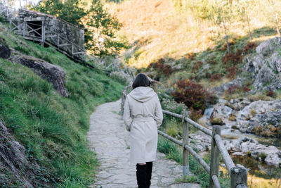 Rear view of woman walking on mountain