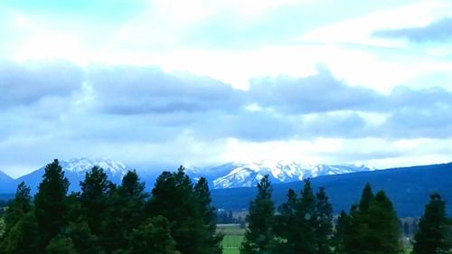 Scenic view of mountains against cloudy sky