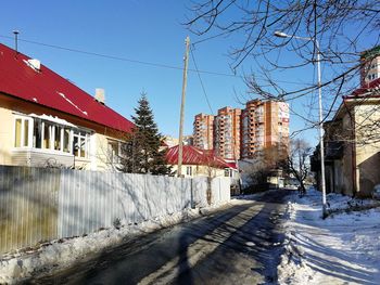 Buildings in city against clear sky during winter