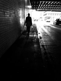 Rear view of silhouette man walking in corridor