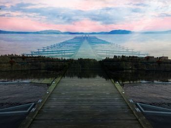 Pier in sea against cloudy sky