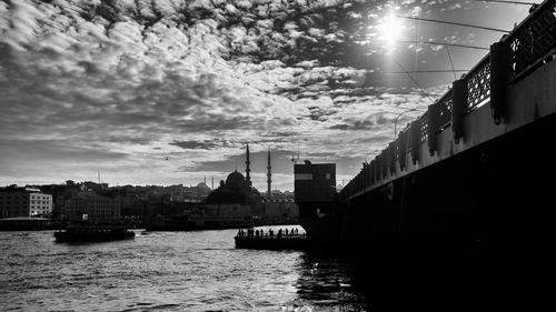 Scenic view of river by buildings in city against sky