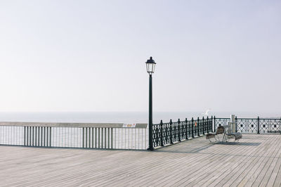 Pier on sea against clear sky