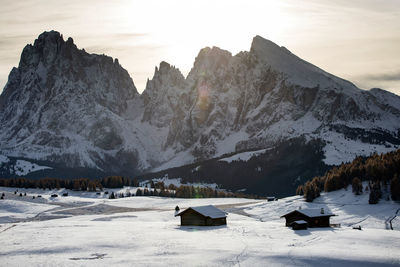 Scenic view of snow covered land and mountains against sky