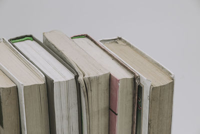 Close-up of books on table against white background