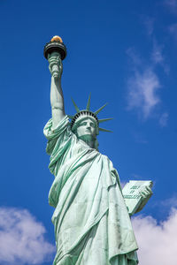 Low angle view of statue of liberty against sky