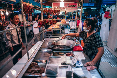 People working at market stall