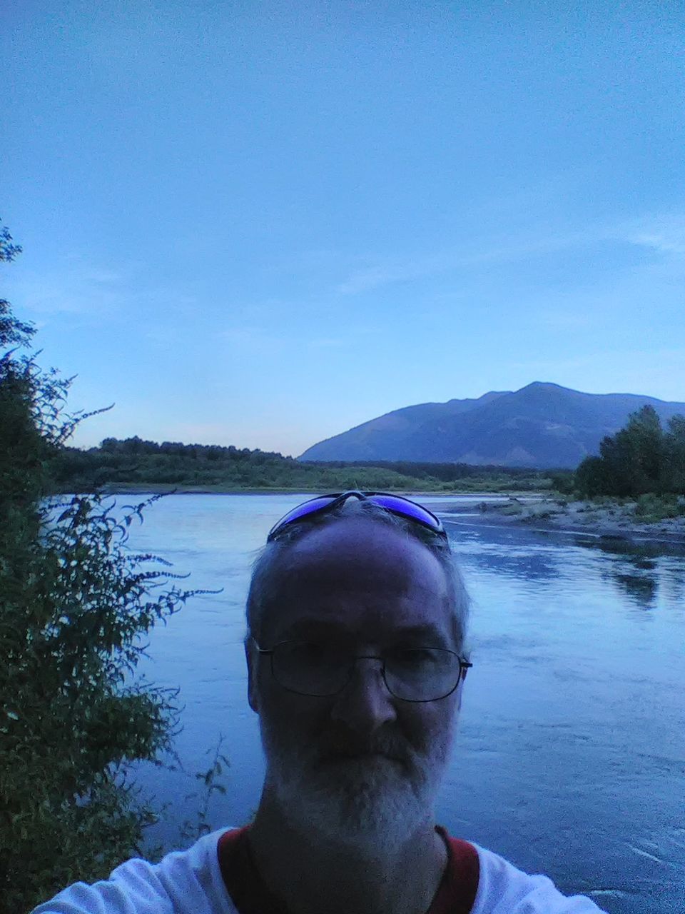 PORTRAIT OF MATURE MAN AGAINST SKY