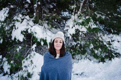 Beautiful woman in snowy mountain covered in blanket. winter season. nature