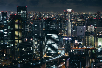 Illuminated modern buildings in city at night