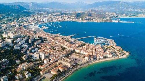 Aerial view of buildings in city by sea