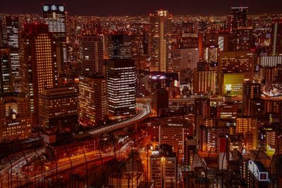 High angle view of illuminated city buildings at night