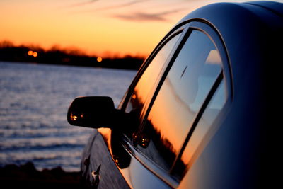 Close-up of cropped car at sunset