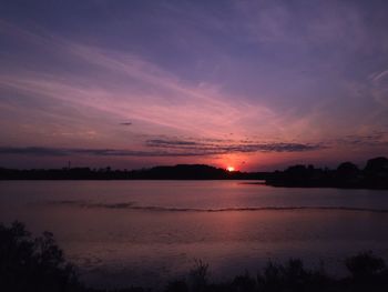 Scenic view of lake against romantic sky at sunset