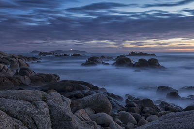 Scenic view of sea against cloudy sky