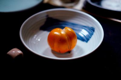 High angle view of persimmon in bowl on table