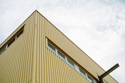 Low angle view of building against cloudy sky