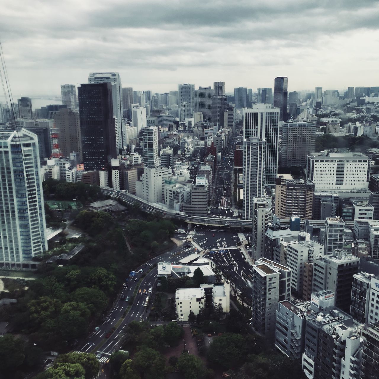 HIGH ANGLE VIEW OF MODERN BUILDINGS IN CITY AGAINST SKY