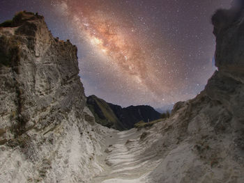 Scenic view of mountains against sky at night