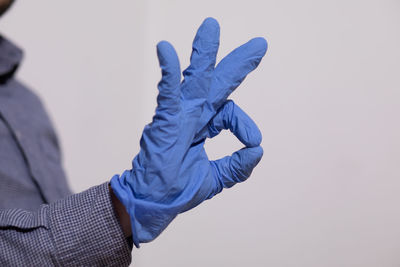 Close-up of man hand against white background