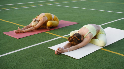 Low section of woman exercising on field