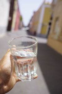 Close-up of hand holding glass of water