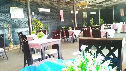 Empty chairs and tables in restaurant
