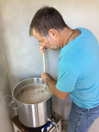 Side view of man preparing food