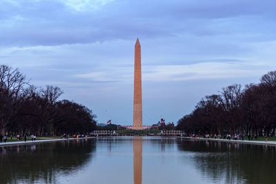 View of monument in lake against sky