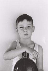 Close-up portrait of boy against wall