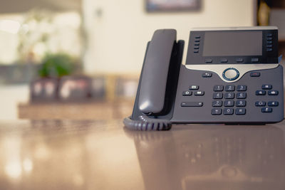 Close-up of telephone booth on table