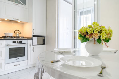 Flower vase on table at home