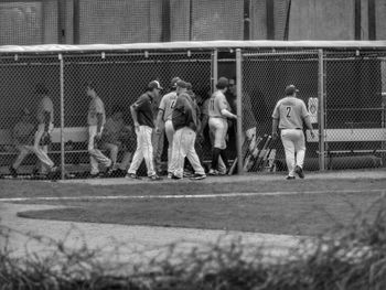 Group of people playing on fence