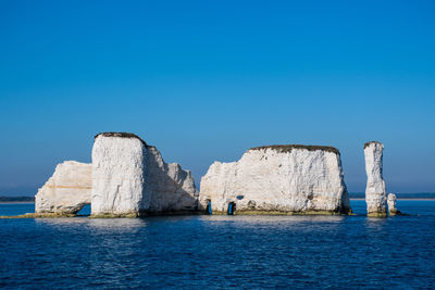 Scenic view of sea against clear blue sky