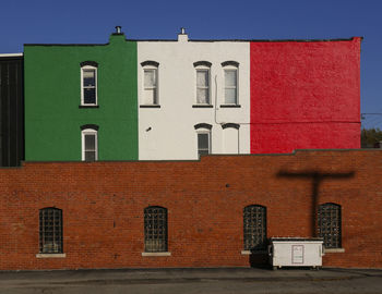 Italian flag paint on building against clear sky