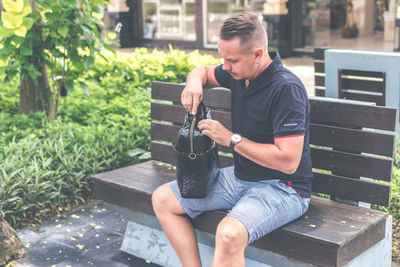 Man sitting on bench in yard