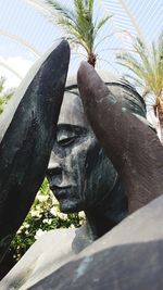 Low angle view of statue against trees