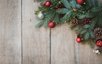 Christmas greenery and decorations against rustic wood backdrop.