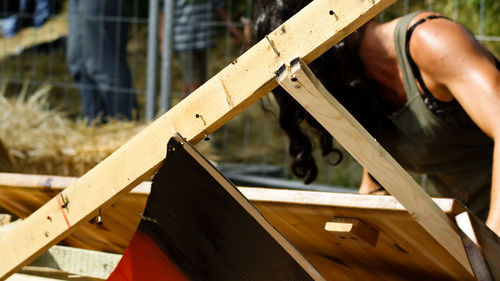 Close-up of woman with wooden structure