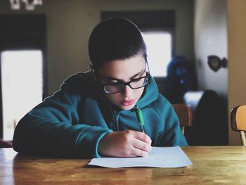 Young man using smart phone on table