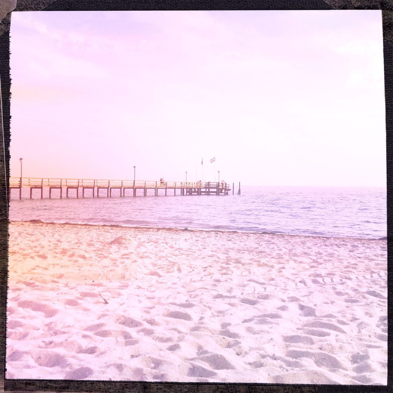 transfer print, sea, water, auto post production filter, horizon over water, beach, sky, tranquil scene, tranquility, scenics, beauty in nature, nature, built structure, sand, shore, pier, waterfront, outdoors, architecture, idyllic