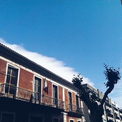 Low angle view of building against blue sky