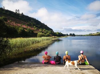 4 ladies sitting at the waters edge