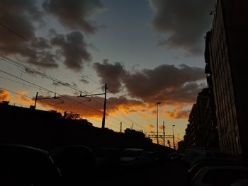 Silhouette of cars against sky during sunset