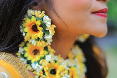 Close-up of woman with pink flower