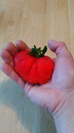 Cropped image of person holding strawberries