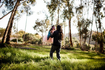 Uncle and niece in dress up playing in field